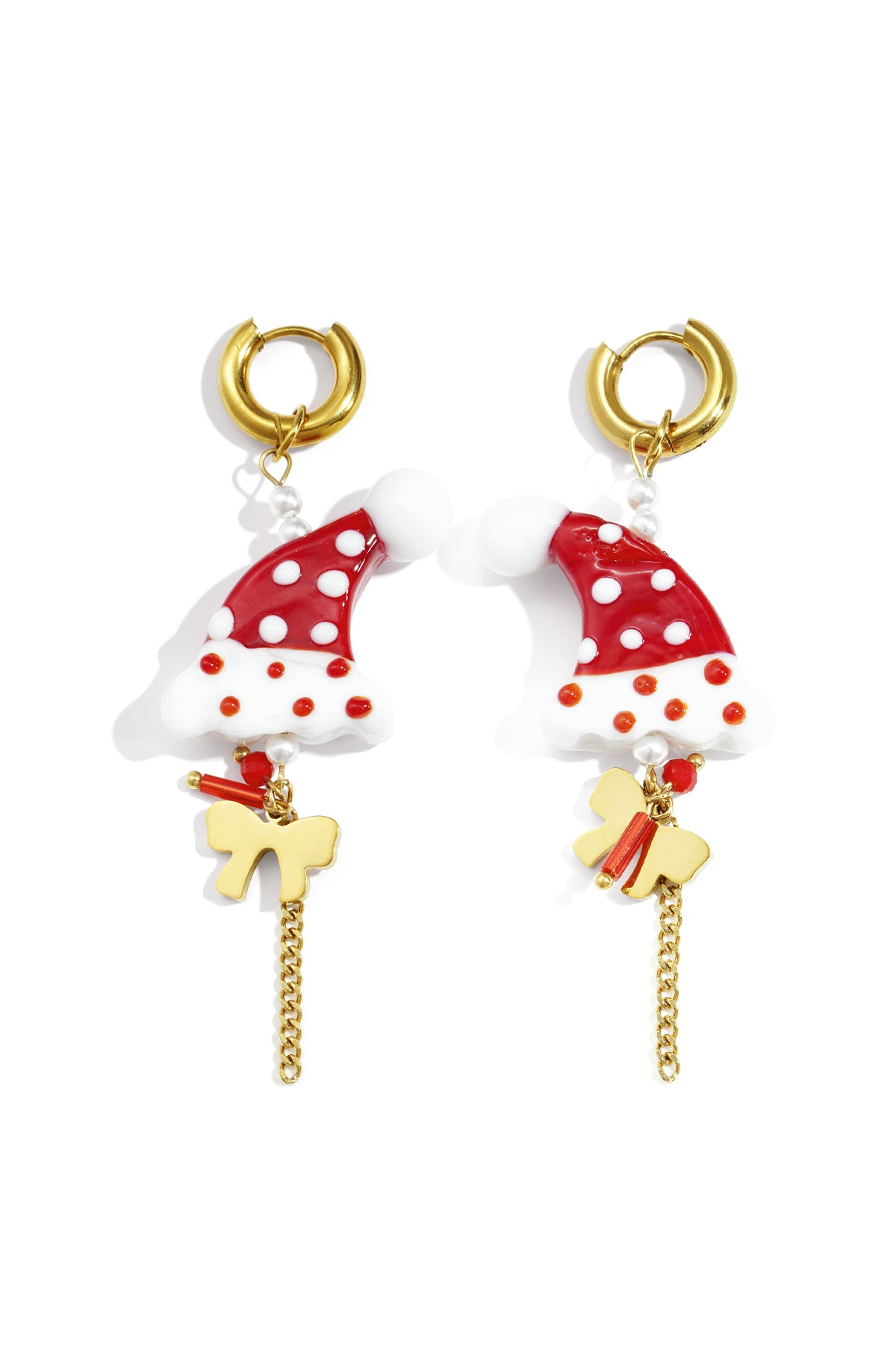 Pair of festive drop earrings featuring red and white polka-dotted Santa hat charms with gold-tone hoops, chains, and bows on white background.