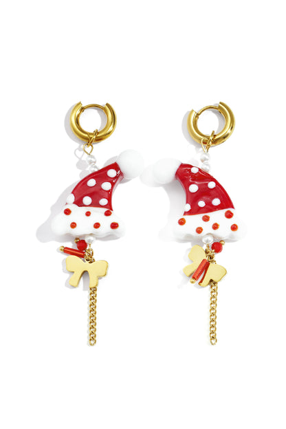 Pair of festive drop earrings featuring red and white polka-dotted Santa hat charms with gold-tone hoops, chains, and bows on white background.