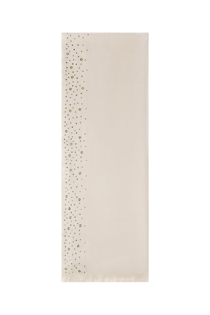Cream winter scarf with gold stud embellishments along one edge flat lay