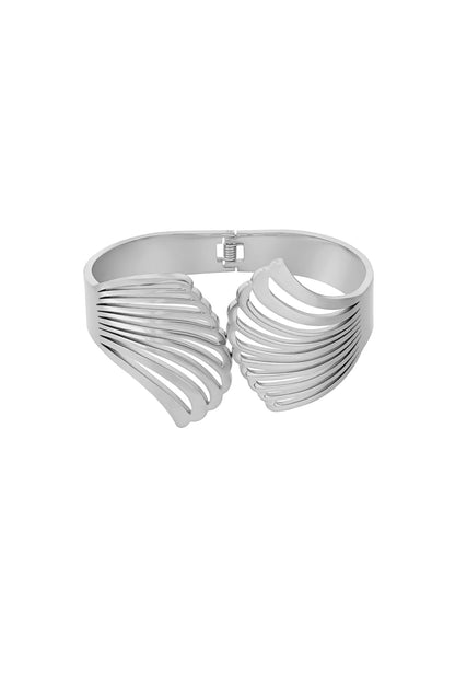 Silver-tone shell design cuff bracelet with open ribbed pattern and hinged clasp on white background