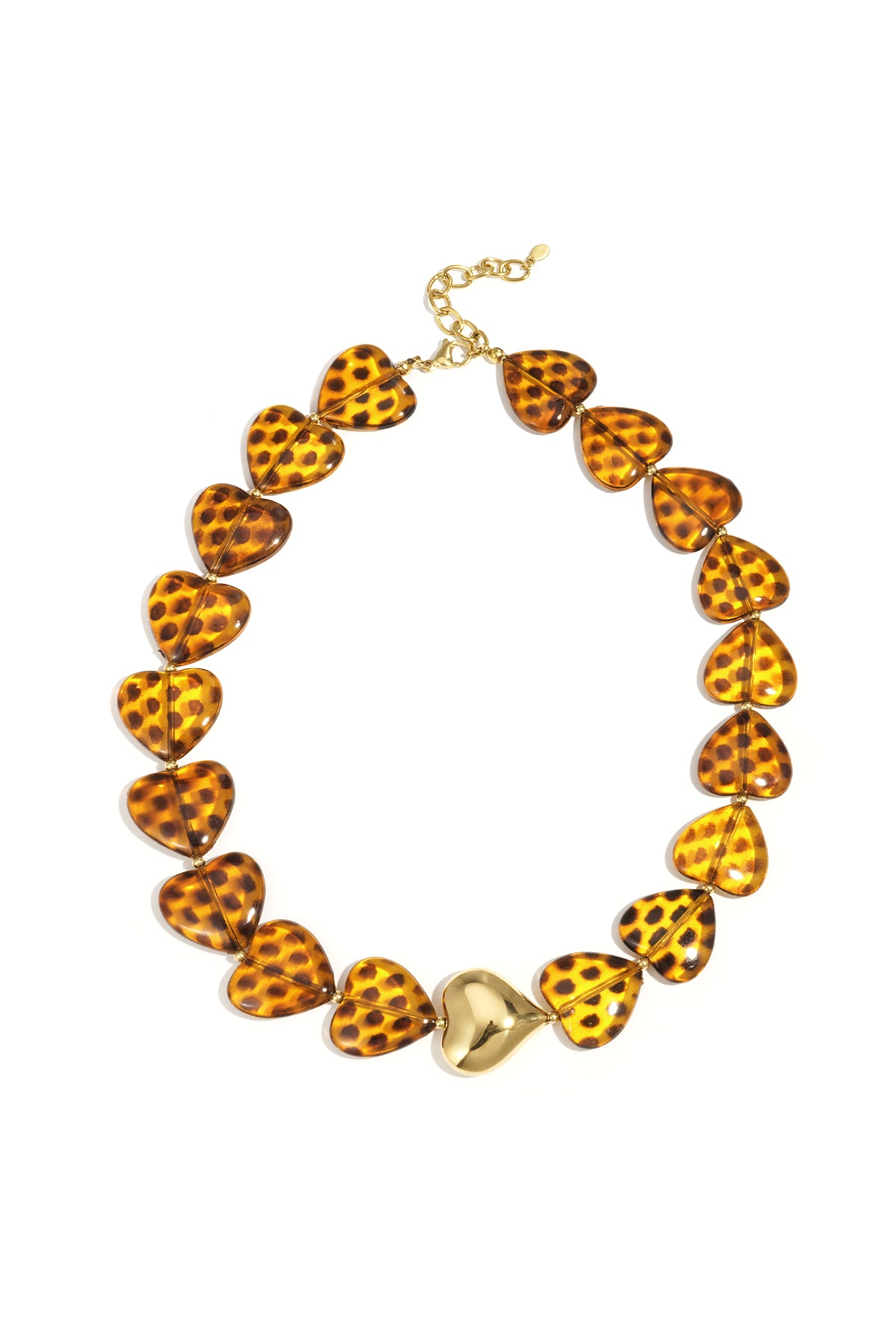 Close-up of amber tortoiseshell heart bead necklace with gold heart centerpiece, set against a white background