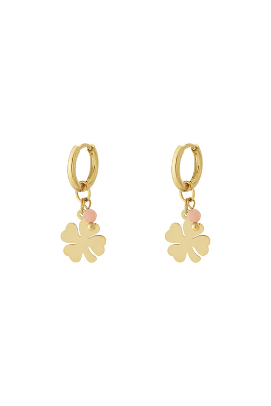 Pair of gold-plated drop earrings featuring four-leaf clover charm with soft pink bead accent on white background