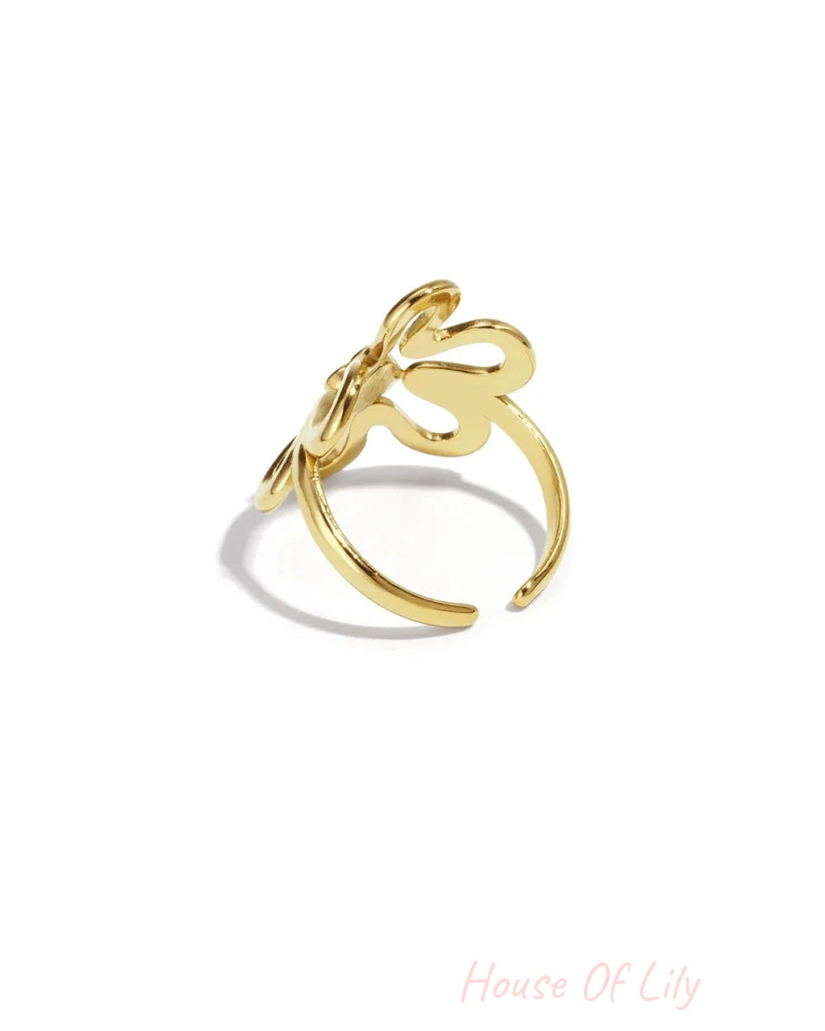 A gold ring with an abstract, organic flower shape on a white background.