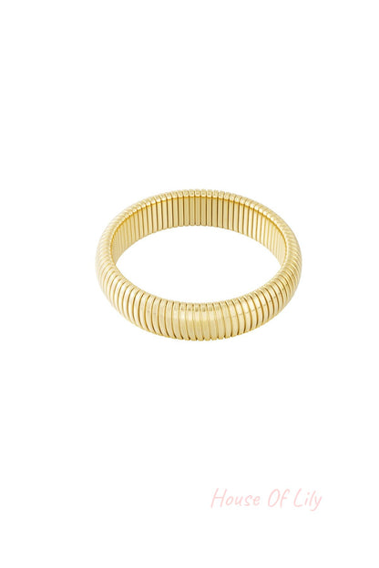 Side view of the silver stretch bracelet displaying tubular segments and shine