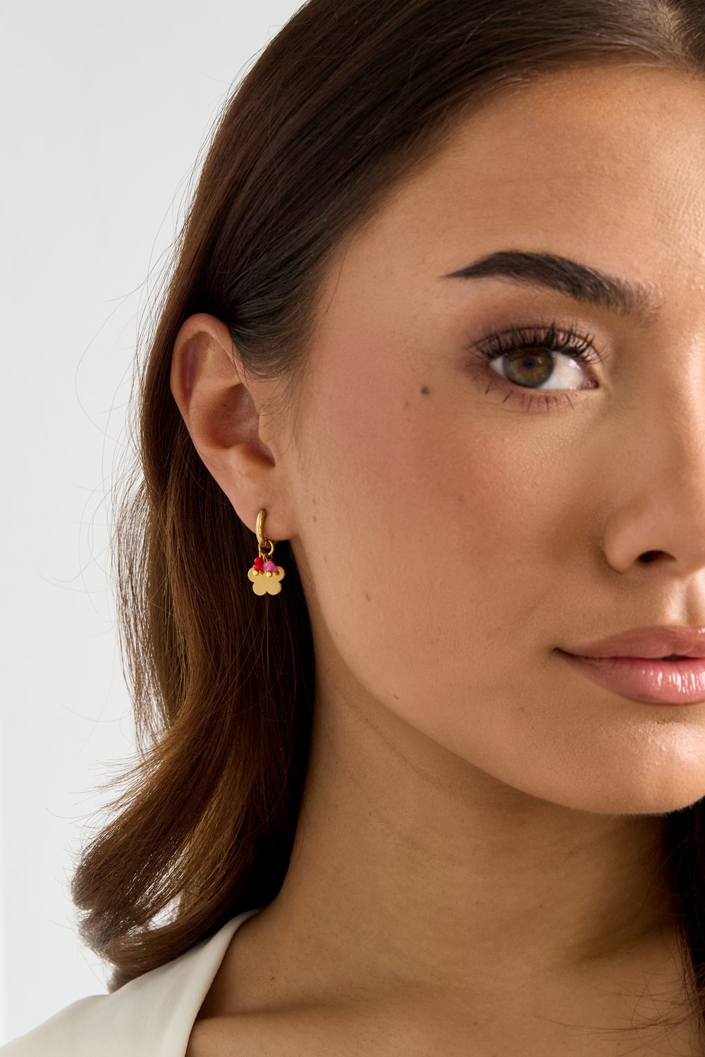 Bloom Core Hoops: Gold huggie earrings with a delicate flower charm featuring tiny pink and red beaded centers.