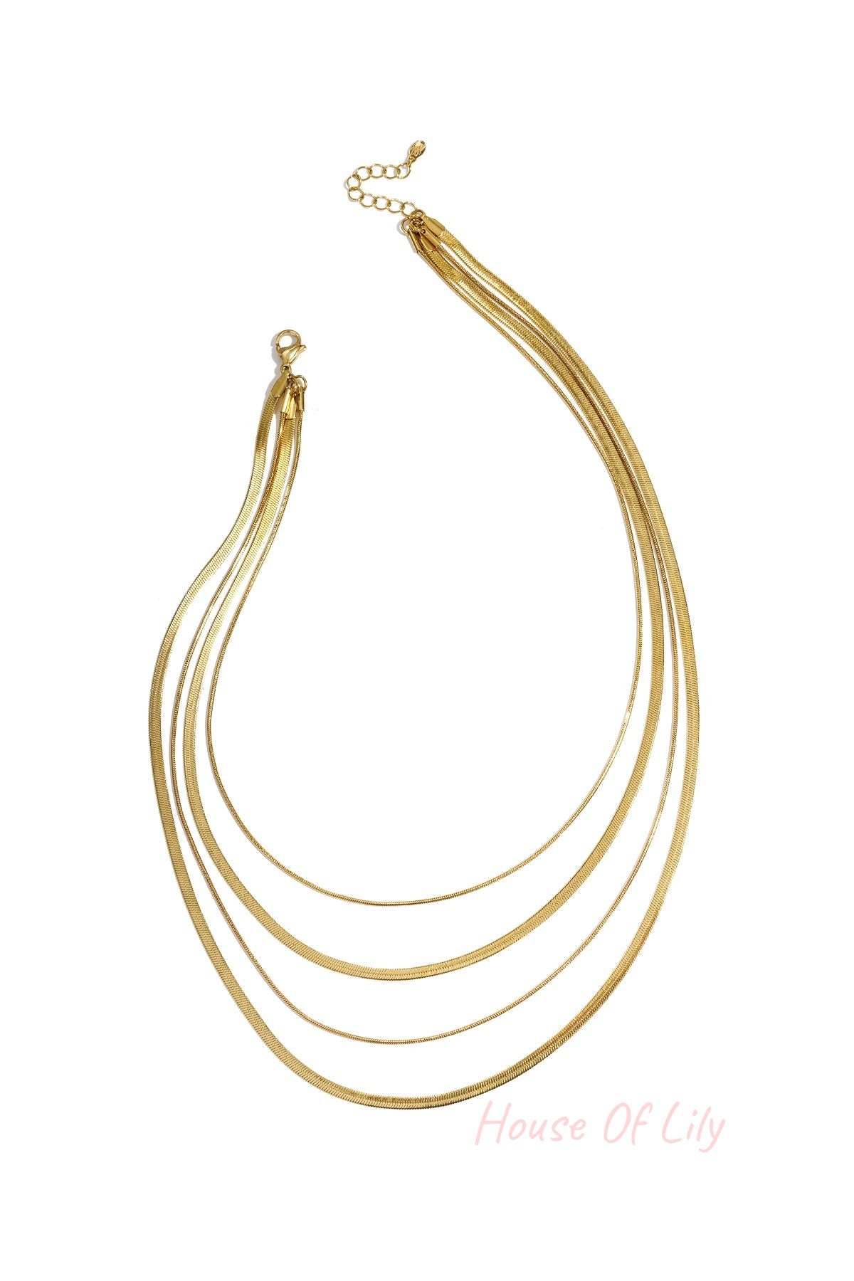 Four-strand gold layered necklace on white background with lobster clasp