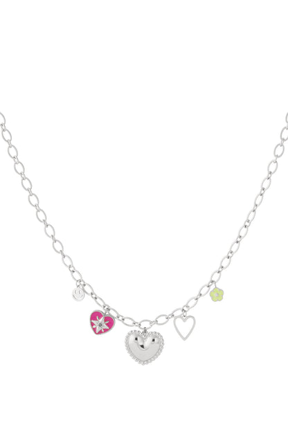 Silver-tone heart charm necklace with pink enamel heart, green flower, smiley face, and open heart charms on oval link chain