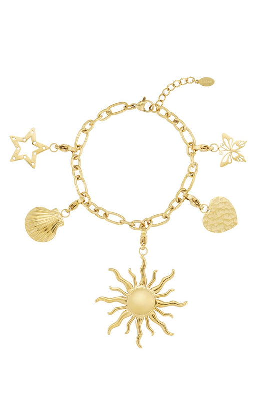 Gold-tone charm bracelet featuring sun, star, seashell, heart, and butterfly charms on a chunky chain.