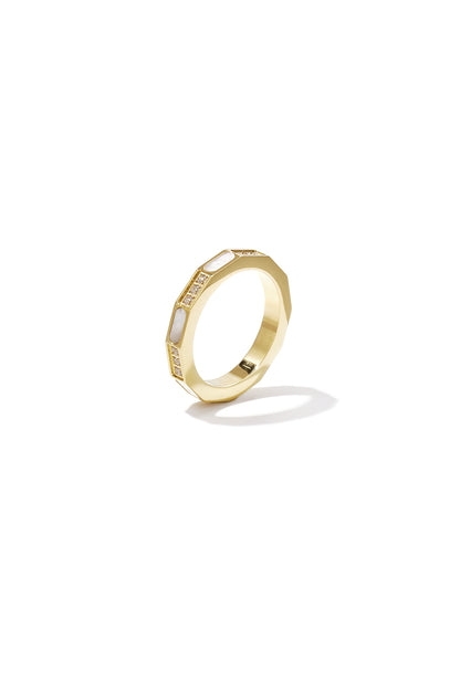 Close-up of a gold geometric ring with mother-of-pearl inlays and zircon stones on white background