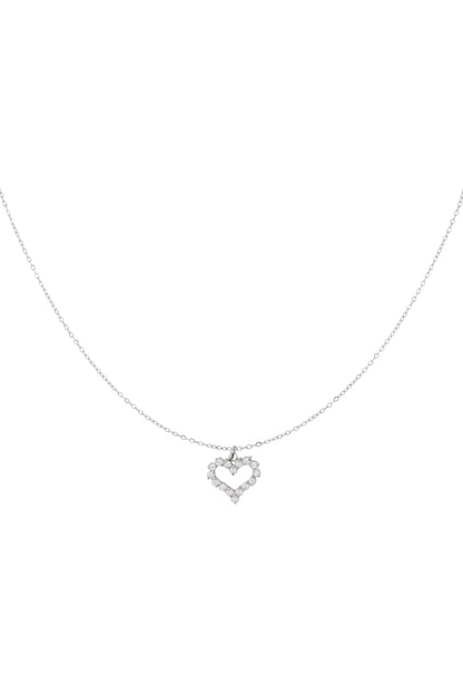 Silver-plated delicate open heart rhinestone pendant necklace on white background