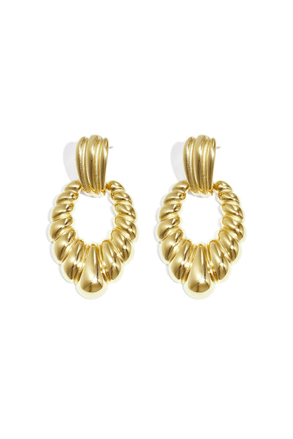 Pair of chic twisted gold hoop earrings displayed on a white background