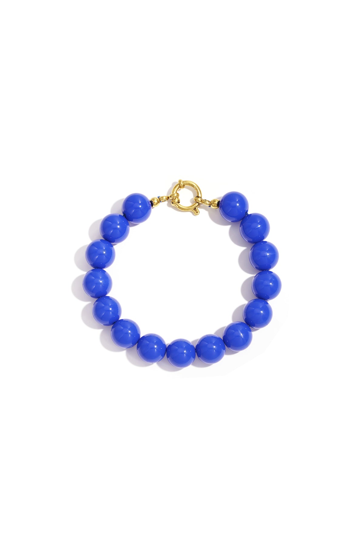 Vibrant blue resin bead bracelet with a gold-tone circular toggle clasp, isolated on a white background.