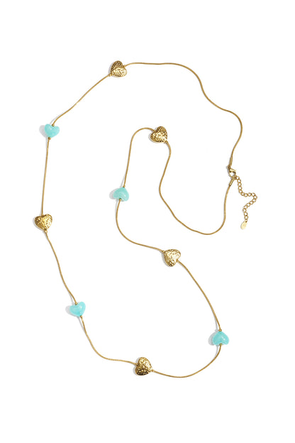 Delicate gold snake chain necklace featuring alternating gold and turquoise blue heart charms on white background