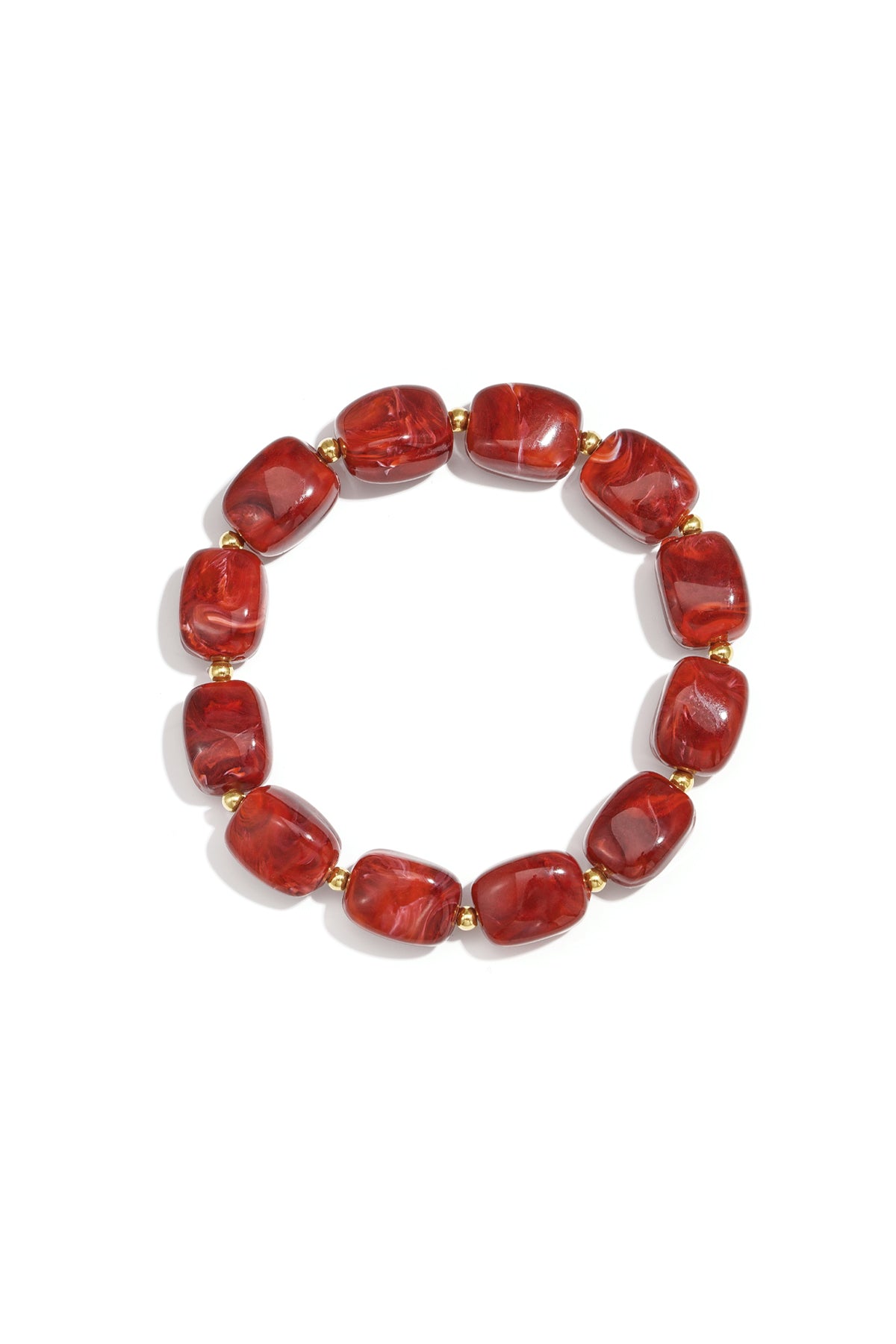 Red acrylic chunky bead bracelet with gold spacers on white background