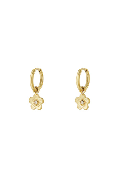 Pair of gold-tone hoop earrings with small flower-shaped charms featuring rhinestone centres on a white background