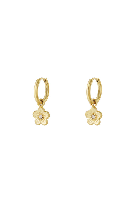 Pair of gold-tone hoop earrings with small flower-shaped charms featuring rhinestone centres on a white background