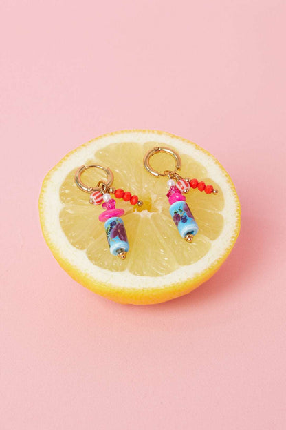 Earrings with dangling beads and a floral print