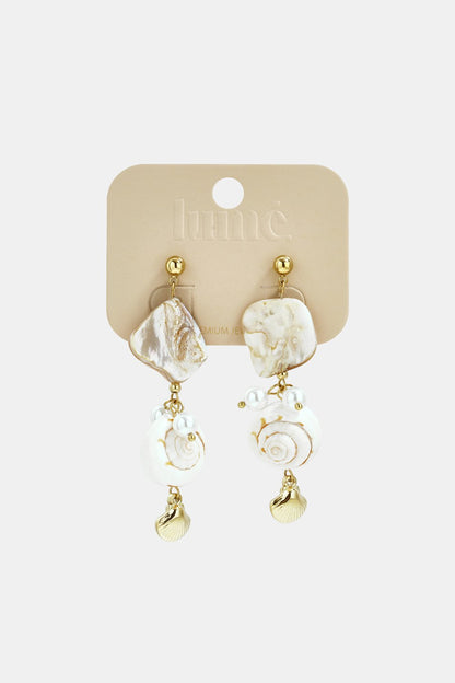 Coastal dangle earrings featuring gold-tone hardware, white shell charms, irregular mother-of-pearl accents, and pearls.