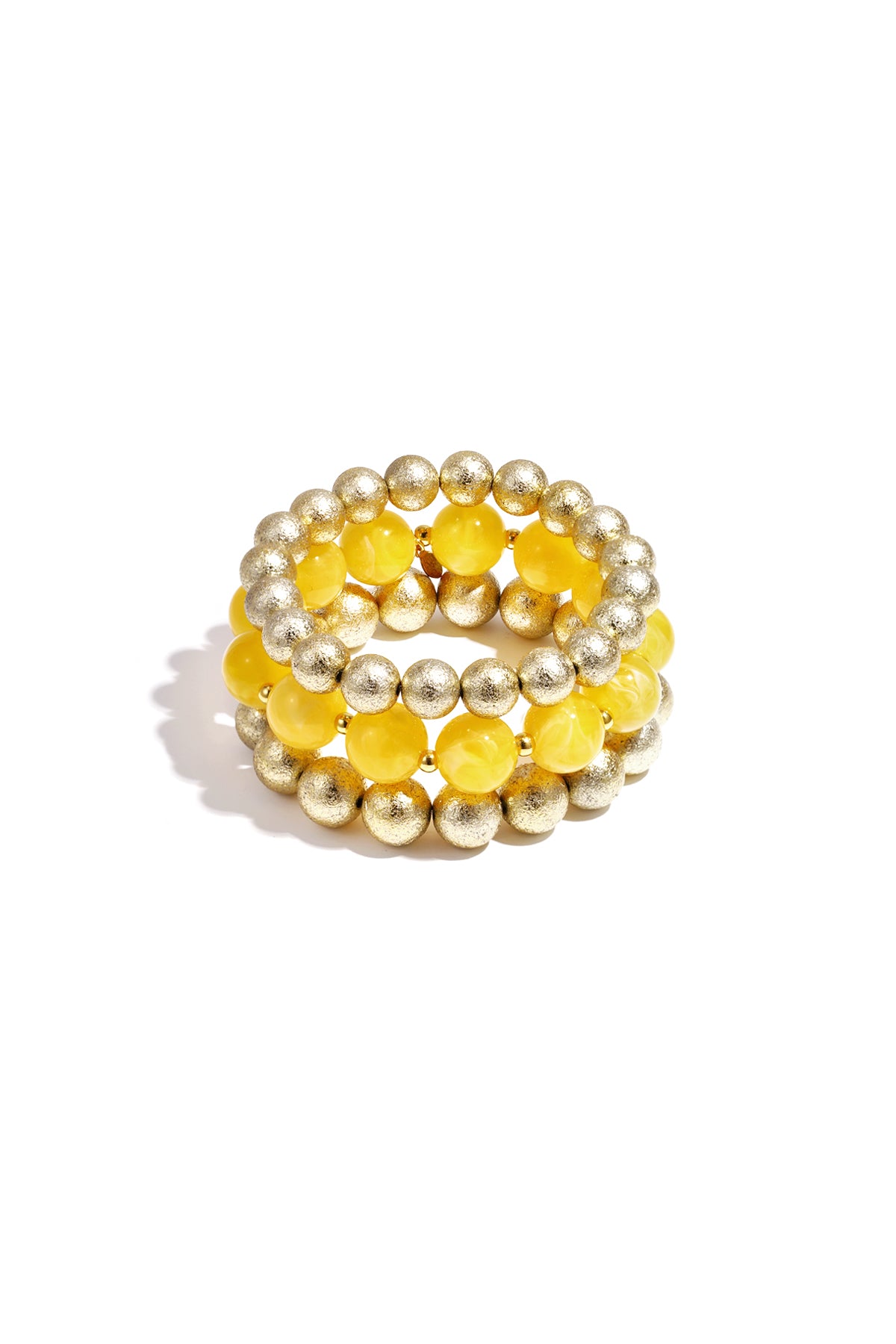 Set of three beaded bracelets with mint green marbled beads and textured gold spheres on white background
