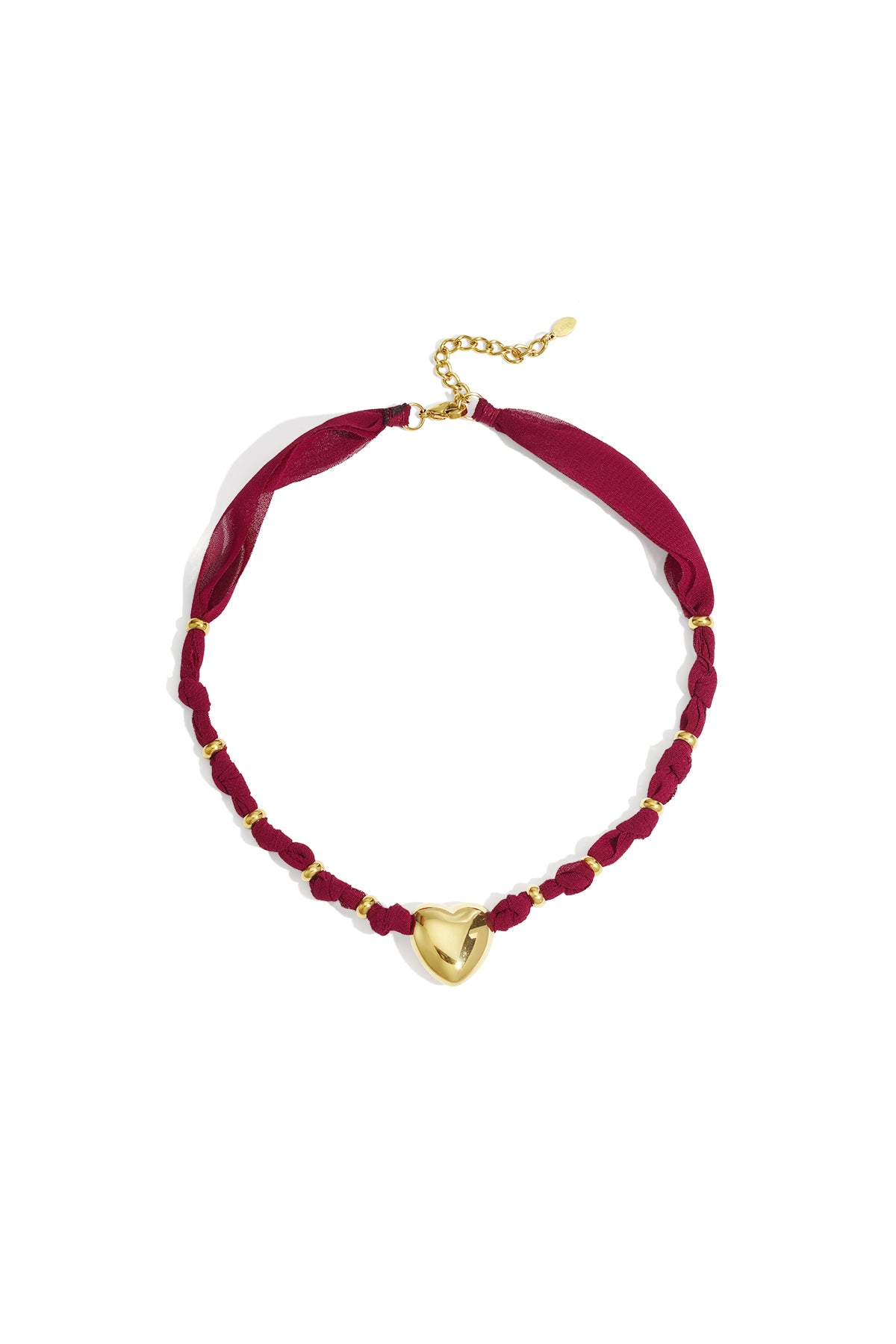 Gold heart pendant necklace with burgundy braided fabric and gold accents on white background