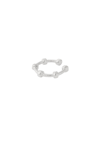 Silver geometric ear cuff shown on white background with textured band and cubic nodes