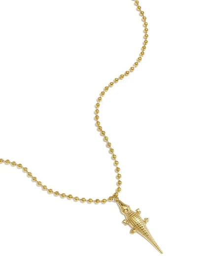 Gold ball-chain necklace with a textured alligator pendant on a white background.
