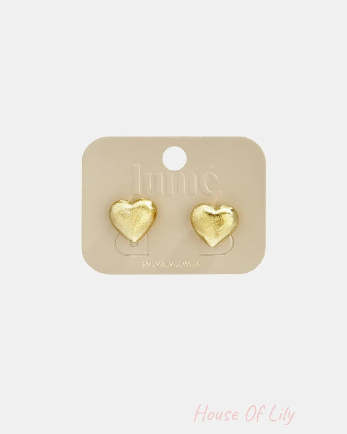 Brushed gold heart-shaped stud earrings displayed on a beige card.