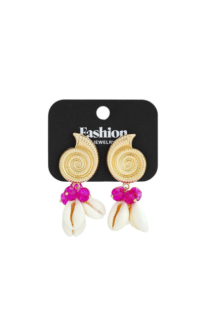 Gold spiral shell earrings with bright pink crystal beads and hanging white cowrie shells on a black display card.