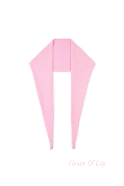 Soft pink knit triangle scarf laid flat