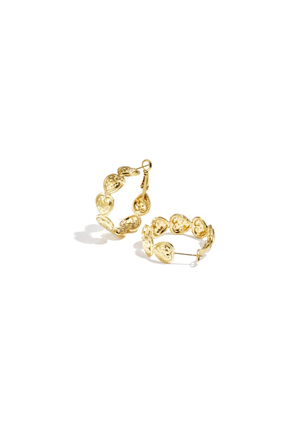 Pair of gold hoop earrings composed of small embossed hearts arranged in a circle on a white background