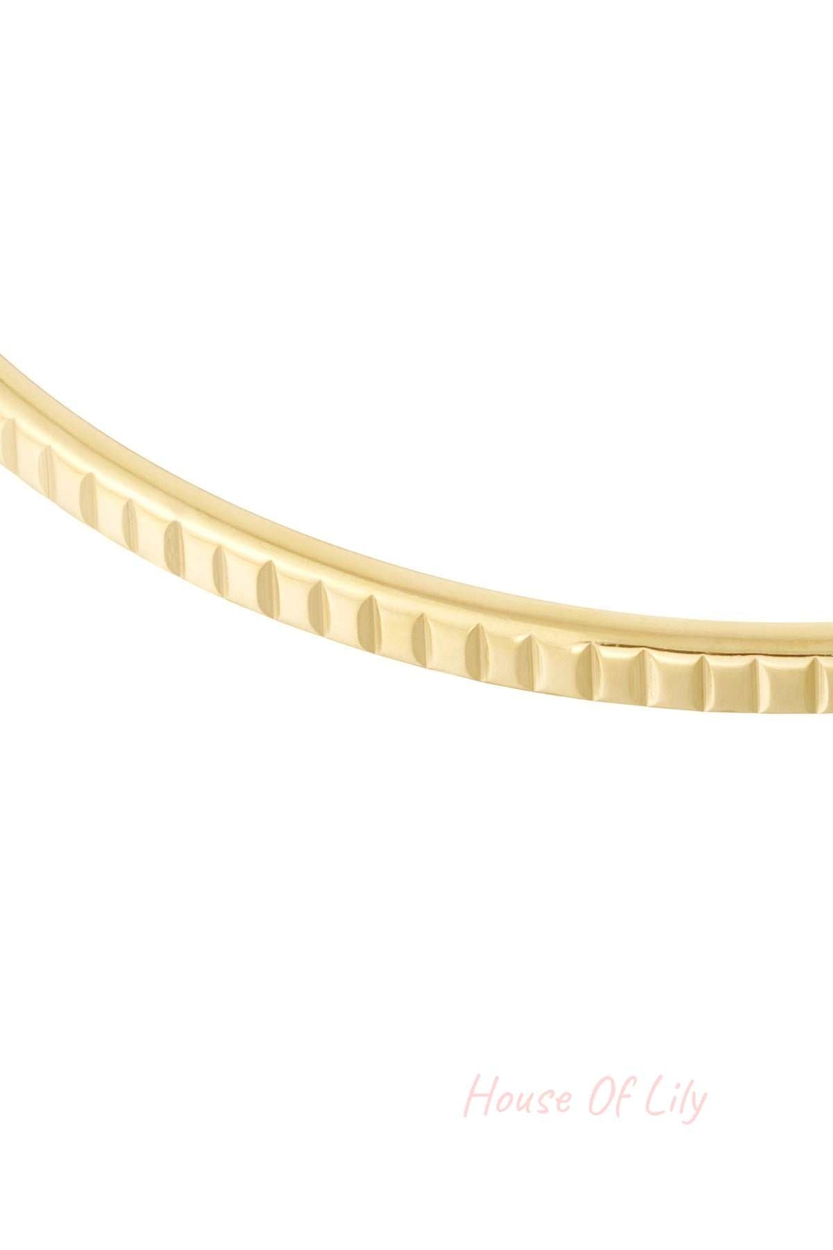 Gold Hammered Groove Bangle featuring a polished, curved band with repeating vertical indented grooves.