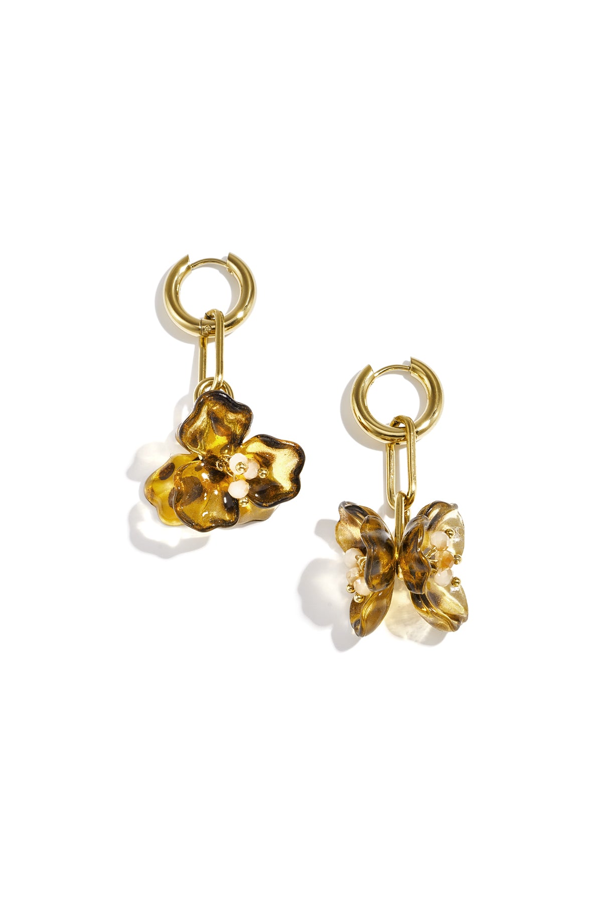 Pair of gold-tone drop earrings with amber acrylic flower pendants on a white background