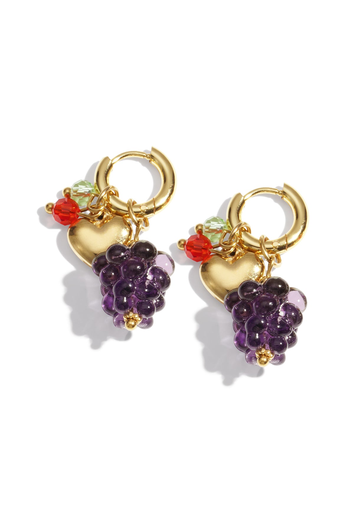 Pair of gold-tone hoop earrings featuring purple grape cluster glass beads, a gold heart charm, and small colorful crystal accents on white background