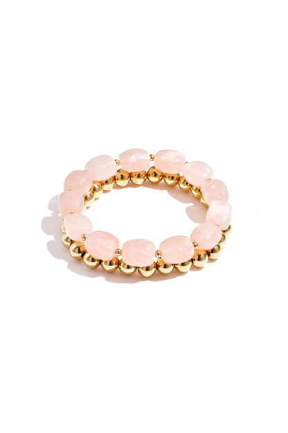 Light blue marbled acrylic beaded bracelet combined with shiny gold-tone beaded bracelet on white background