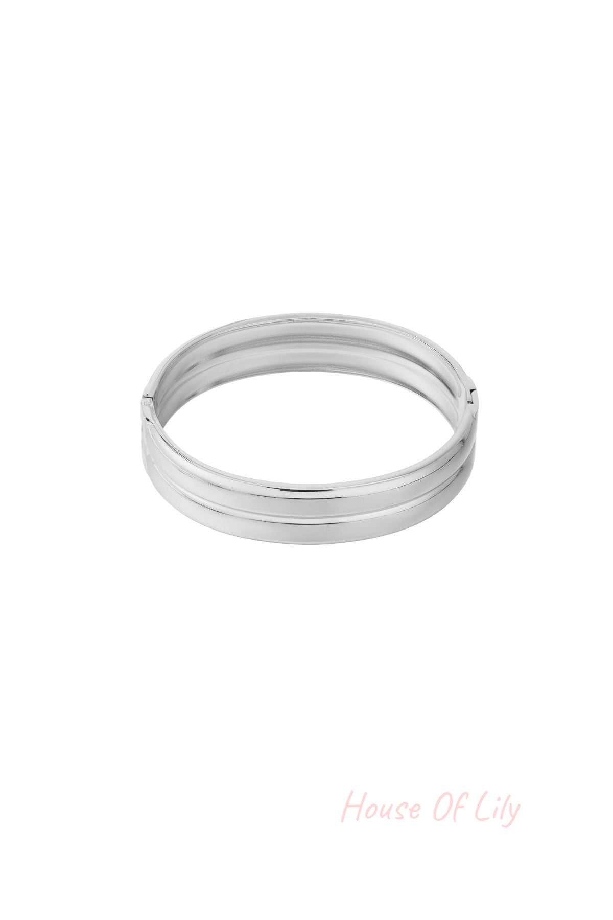 Close-up image of a polished silver minimalist double-band bangle with smooth finish on white background