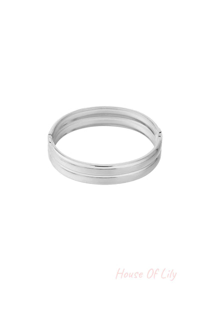 Close-up image of a polished silver minimalist double-band bangle with smooth finish on white background