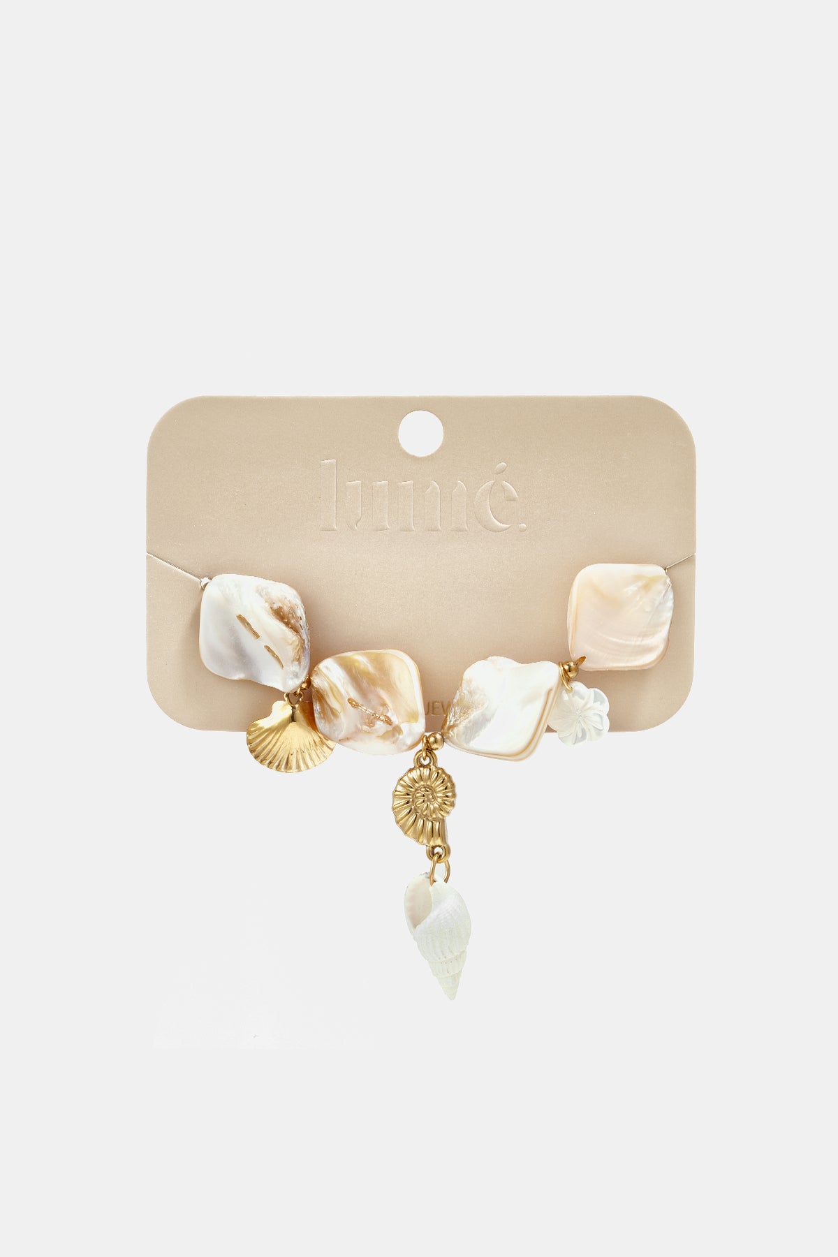 Coastal bracelet featuring iridescent square shell beads, gold seashell charms, and a white spiral shell drop.