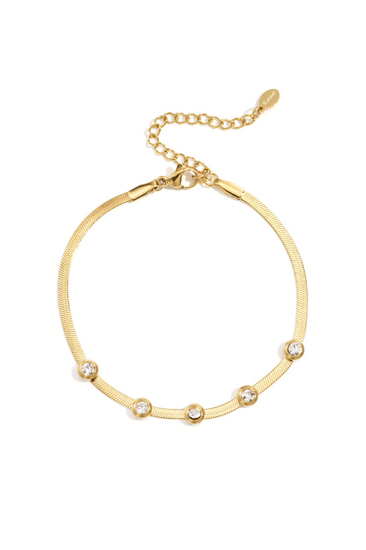 Gold-tone chain bracelet featuring five clear rhinestones and adjustable lobster clasp on white background