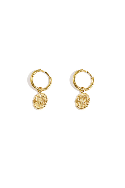Pair of gold floral charm hoop earrings on white background