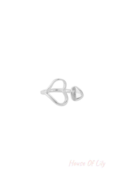 Silver-tone heart-shaped open ring with a small rounded end detail on white background