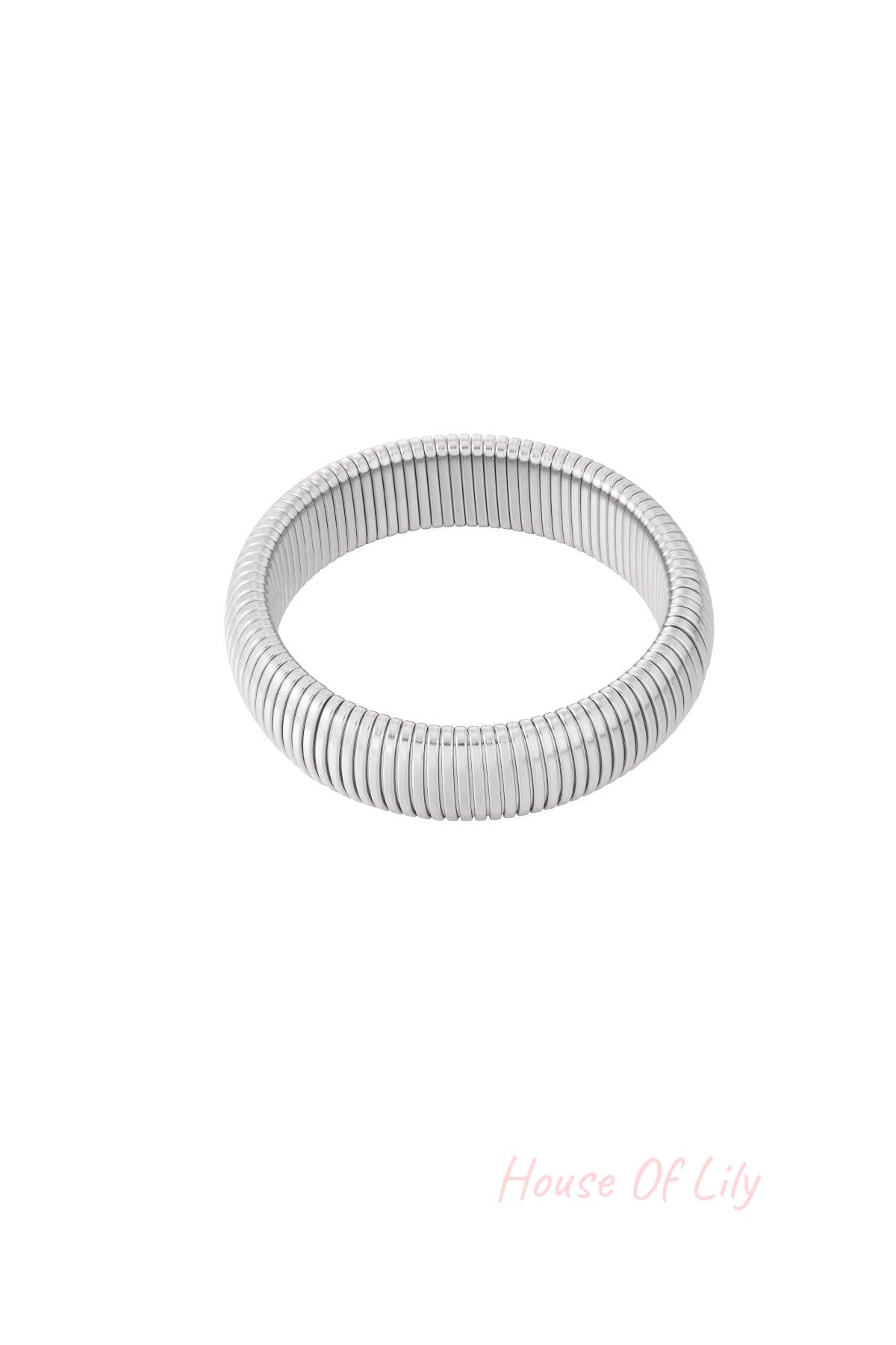 Close-up shot of a silver stretch bracelet with tubular segmented design on white background