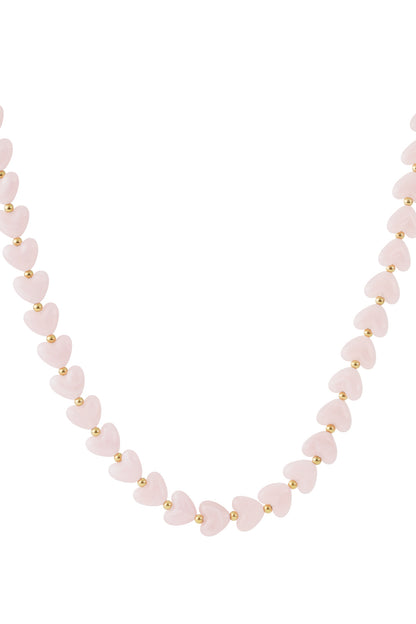 Light peach marbled heart bead necklace with gold spacers on white background