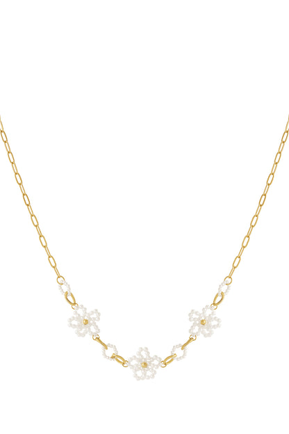 Gold-plated chain necklace with small white pearl flowers evenly spaced along the chain on a white background