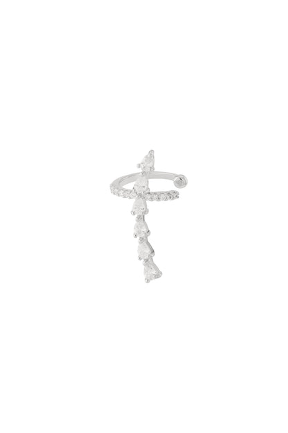 Silver tone ear cuff with cascading pear-shaped cubic zirconia stones on a white background