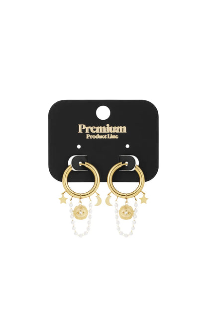 Gold hoop earrings with celestial star, moon, sun-eye charms, and delicate pearl chain drapes on a black display card.