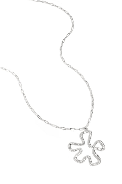 Silver version of the wavy abstract flower pendant necklace on white background with link chain visible