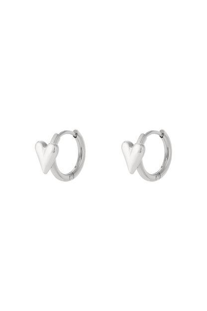 Pair of silver heart hoop earrings displayed on white background