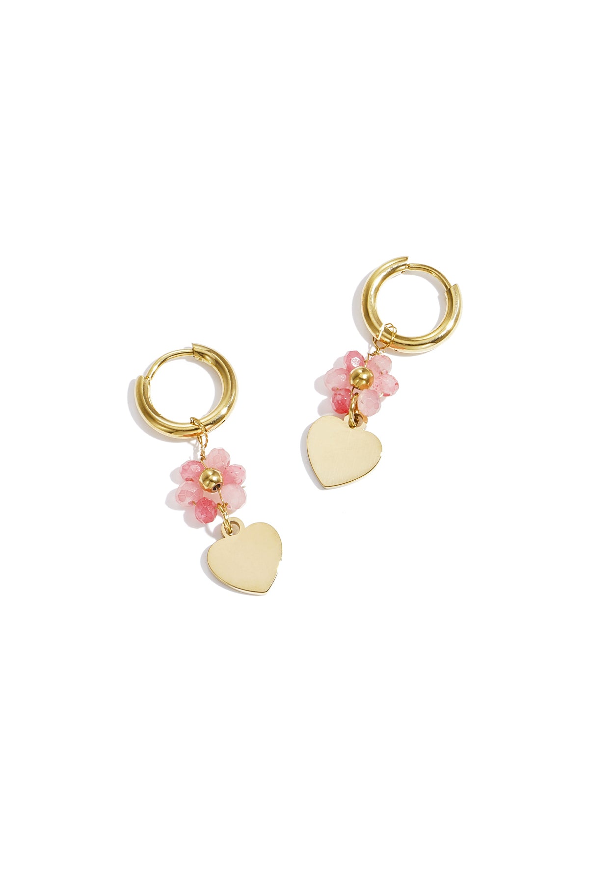 Pair of gold-tone hoop earrings with soft pink faceted beads and dangling gold heart charms on white background