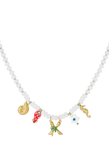 White beaded necklace with gold sea-themed charms including a shell, red fish, palm tree, evil eye, and seahorse.