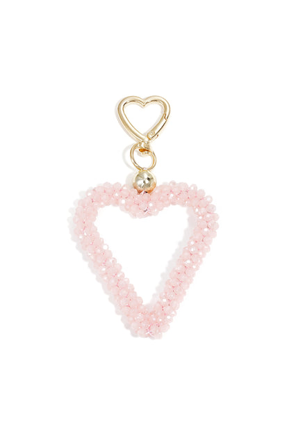 Light pink beaded heart keychain with gold hardware on white background